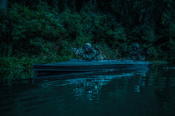 Special forces men with painted faces in camouflage uniforms paddling army kayak. Boat moving...