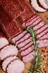 Set of cold cuts on a wooden board. Mix of sausages