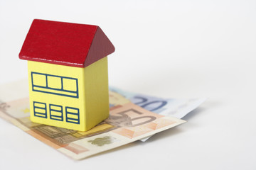 Toy house on Euro banknotes