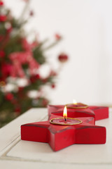 Star shaped candleholder with burning tea candles