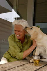 Senior woman playing with a dog