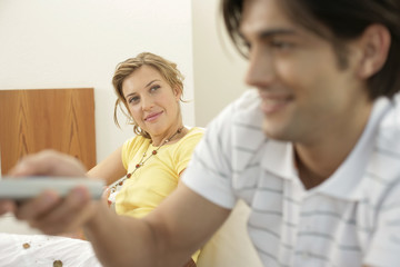 Man watching TV, woman watching him