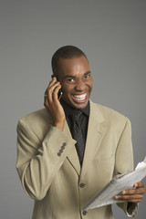 Laughing businessman phoning with a mobile phone