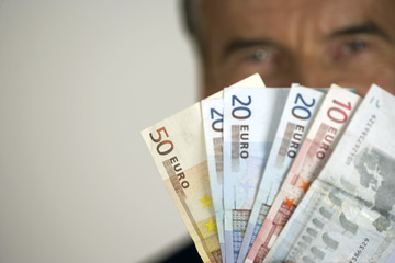 Senior businessman holding banknotes