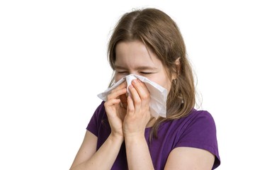 Allergy concept. Young allergic woman is sneezing and blowing her nose. Isolated on white...