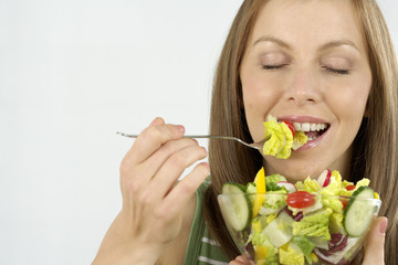 Mid adult woman eating salad