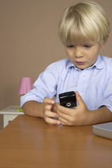 Boy (4-5 Years) holding a mobile phone