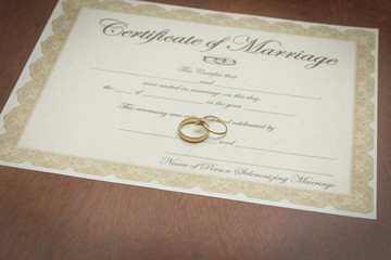 gold wedding rings with a marriage certificate 