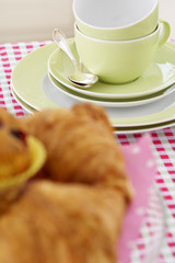 Pastry on a table next to crockery, close-up, selective focus