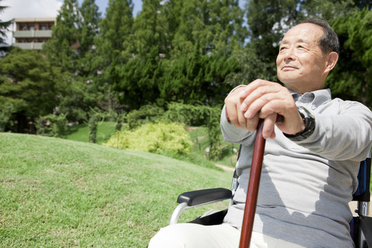 Senior man in wheelchair in park