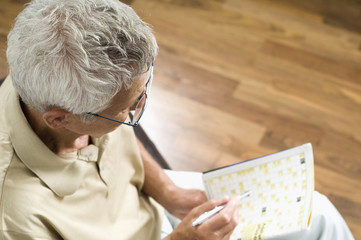 Fototapeta na wymiar Senior man completing crossword