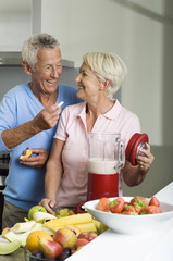 Senior couple preparing a milkshake