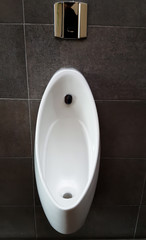 Fototapeta premium line of white porcelain urinals in public toilets