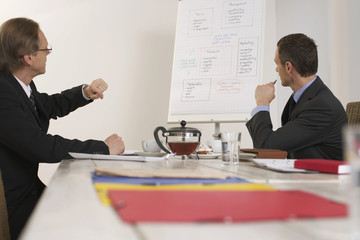 Two men sitting on a bargaining table