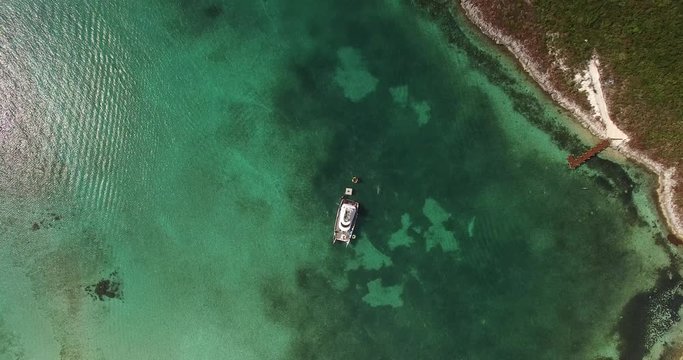 Top View of a yacht on green reef ocean, Bahamas