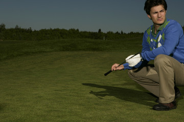 Fototapeta premium Young man on golf course