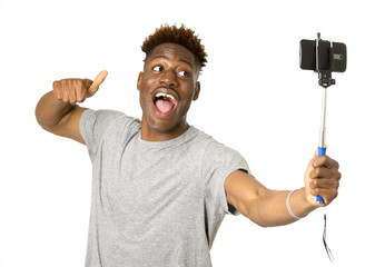 young afro american man smiling happy taking selfie self portrait picture with mobile phone