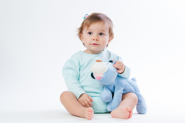 Portrait of a smiling child with a toy bear, isolated on a white background