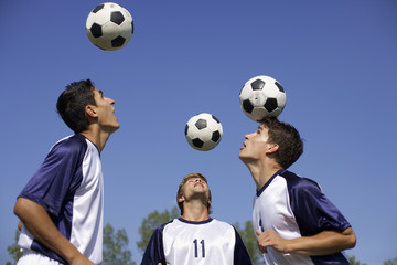 Soccer players heading balls
