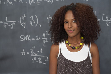 Mixed race woman in front of a blackboard, close-up