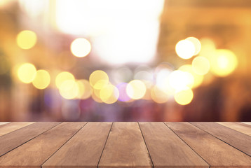 Wood table top with abstract blurred light bokeh background