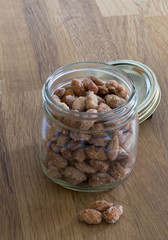 Roasted Almonds in a mason jar on wood table 