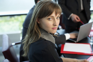 Businesswoman in a meeting looking at camera