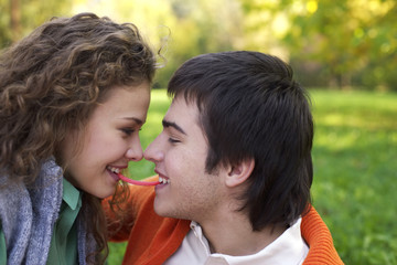 Teenage couple is about kissing one another, close-up, low angle view