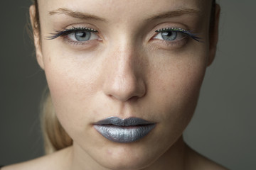 Young woman with silver colored lips (part of), close-up