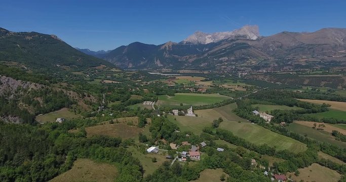 Aerial shot above mountain village and pic de bure