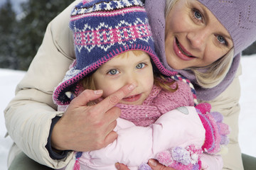 Portrait of mother and daughter in snow
