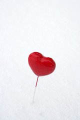 Heart-shaped lollipop in snow