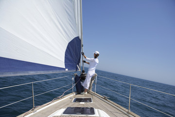 Woman standing on the bow of a sailboat