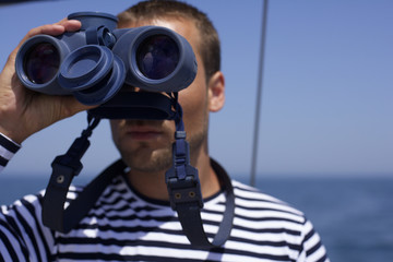 Obraz premium Man looking through a spyglass