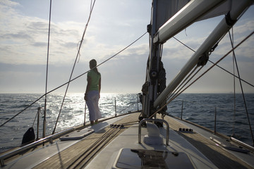 Fototapeta premium Woman standing on a sailing yacht