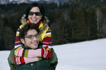 Young couple embracing each other at snow