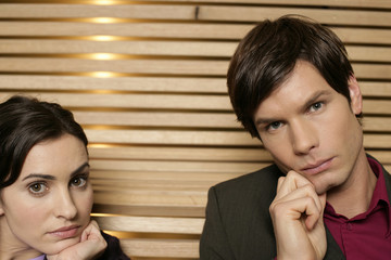 Two reflective businesspeople looking at camera