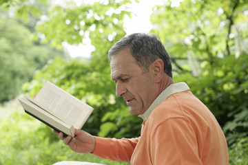 Mature man holding a book