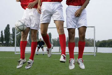 Soccer players forming a wall