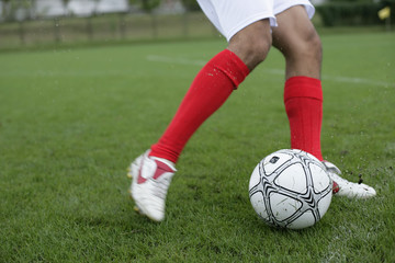 Soccer player kicking football