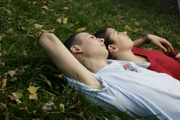 Teenage couple lying on the grass
