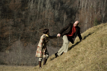 Mature couple walking up a hill