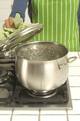 Woman cooking at gas stove