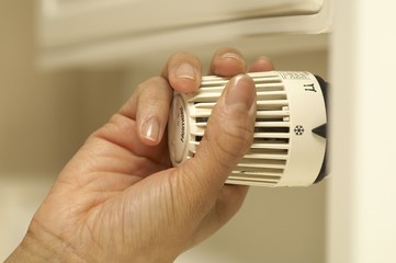 Woman turning off heater