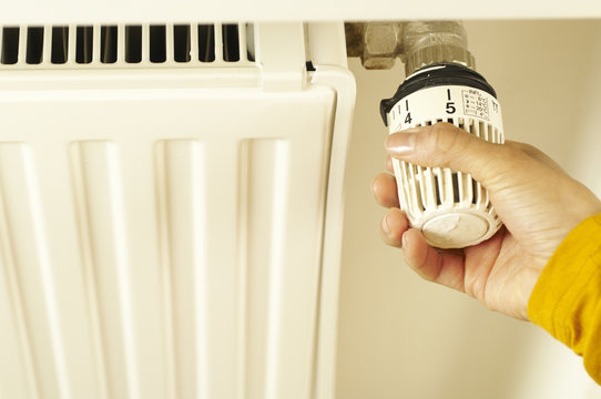 Woman turning on heater