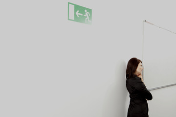 Pensive businesswoman on office corridor, Munich, Bavaria, Germany