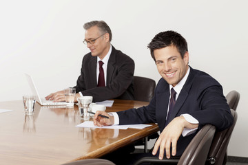 Two businessmen talking in conference room, Munich, Bavaria, Germany