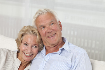 Happy senior couple on sofa