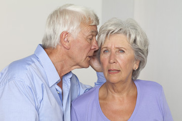 Senior couple whispering