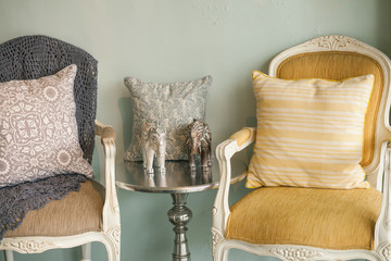 Still life details, fabric pillows on retro vintage wooden arm Chair